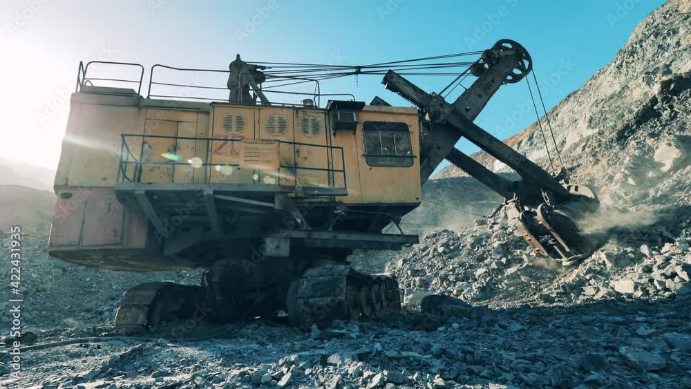 Ore is getting excavated in the mine pit by a truck Ore is getting excavated in the mine pit by a truck