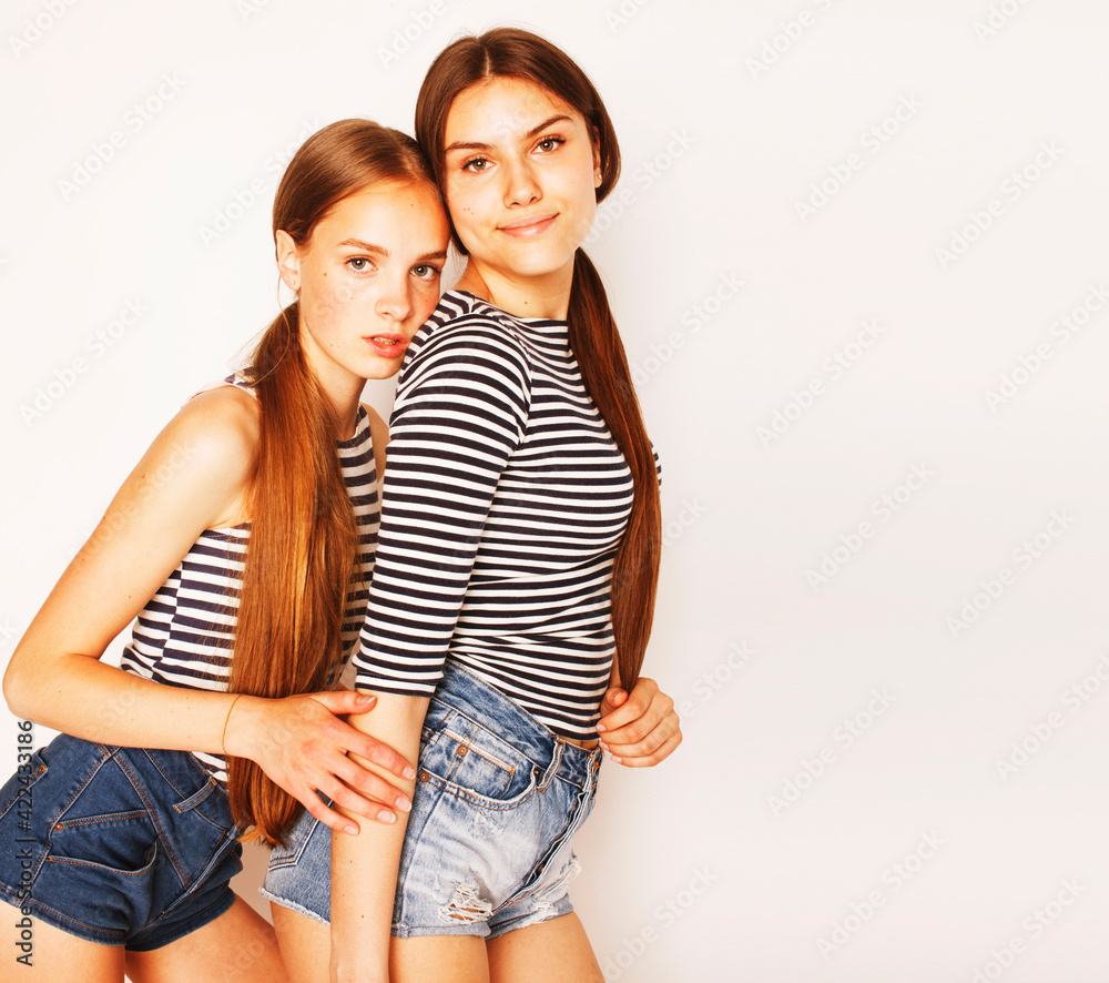 two cute teenagers having fun together isolated on white two cute teenagers having fun together isolated on white