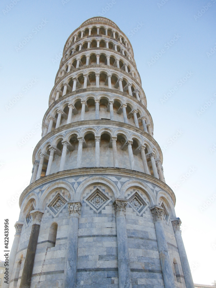 Pisa, Italy. Leaning Tower of Pisa with sunset light and blue sky