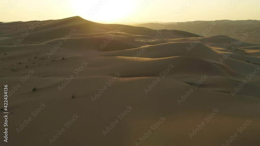 Aerial view of beautiful sandy dunes in Dubai desert at sunset, United Arab Emirates. Aerial view of beautiful sandy dunes in Dubai desert at sunset, United Arab Emirates.