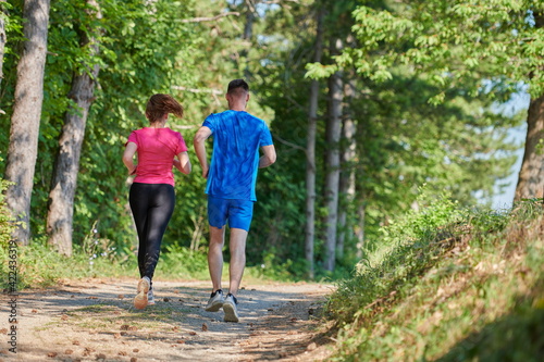 couple enjoying in a healthy lifestyle while jogging on a country road