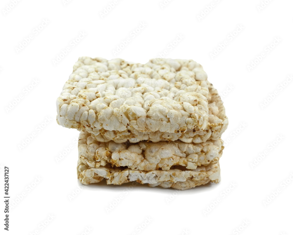 Puffed rice cakes isolated on white. Stack of puffed whole grain crispbread isolated on white. Puffed rice cakes isolated on white. Stack of puffed whole grain crispbread isolated on white.