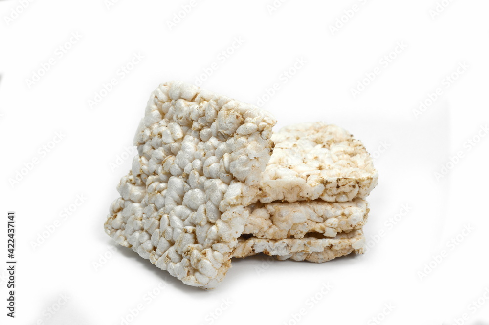 Puffed rice cakes isolated on white. Stack of puffed whole grain crispbread isolated on white.