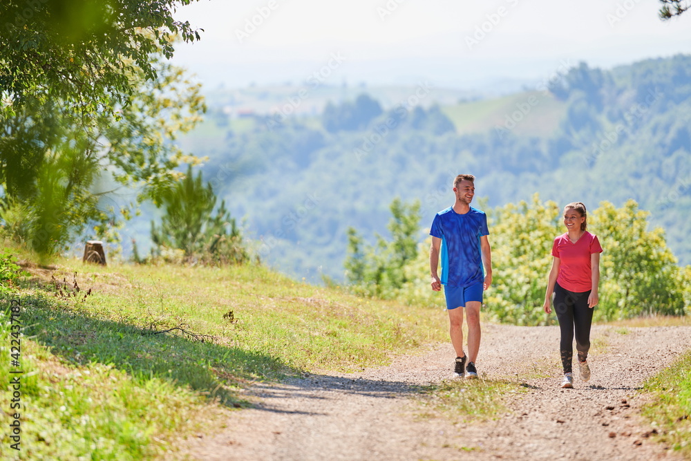 couple enjoying in a healthy lifestyle while jogging on a country road couple enjoying in a healthy lifestyle while jogging on a country road