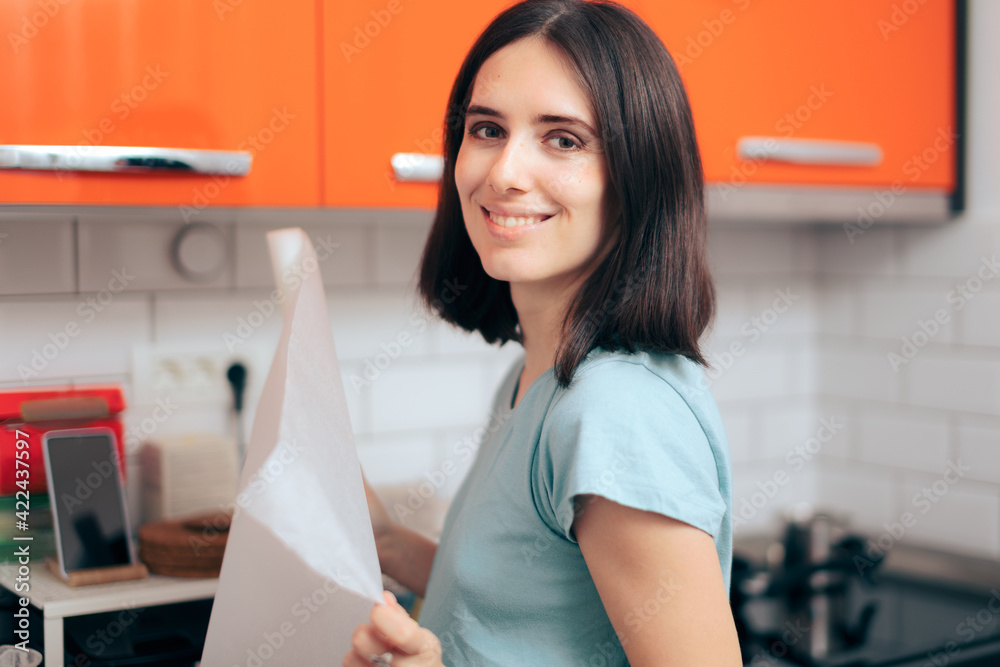 Woman Holding Baking Paper in the Kitchen 