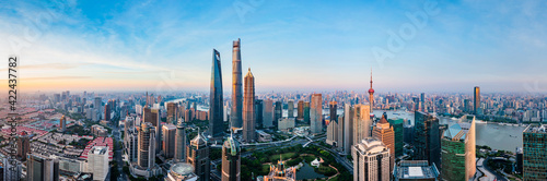 Aerial view of modern city skyline and buildings at sunrise in Shanghai.