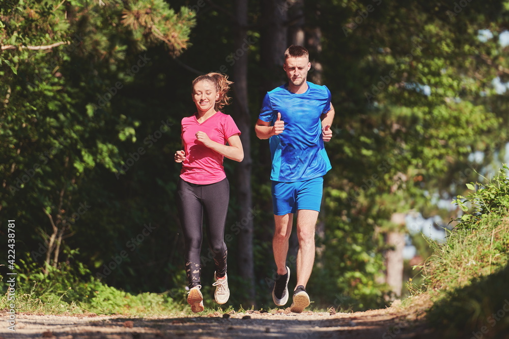 Fototapeta premium couple enjoying in a healthy lifestyle while jogging on a country road