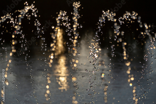 Water splashes at sunset, in the background light. 