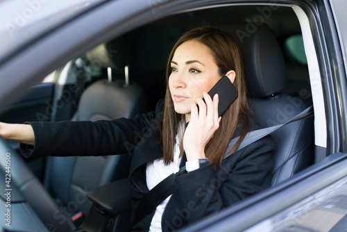 Professional woman calling a work colleague while driving © AntonioDiaz