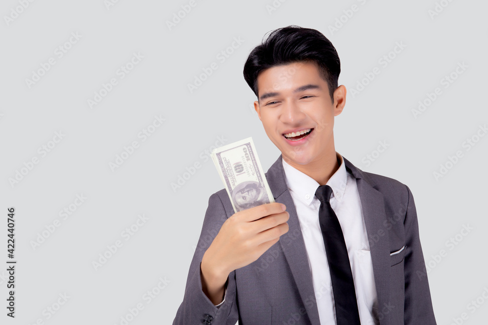 Young asian business man holding money dollar isolated on white background, businessman in suit holding banknote and success and excited with finance, savings and investment, income and spending. Young asian business man holding money dollar isolated on white background, businessman in suit holding banknote and success and excited with finance, savings and investment, income and spending.