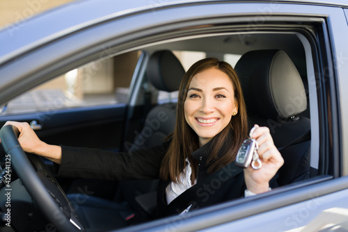 Beautiful woman in her 30s holding her new car keys