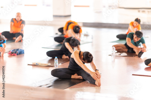 Fotografie Group Of People performing yoga class ,sports and healthcare concept