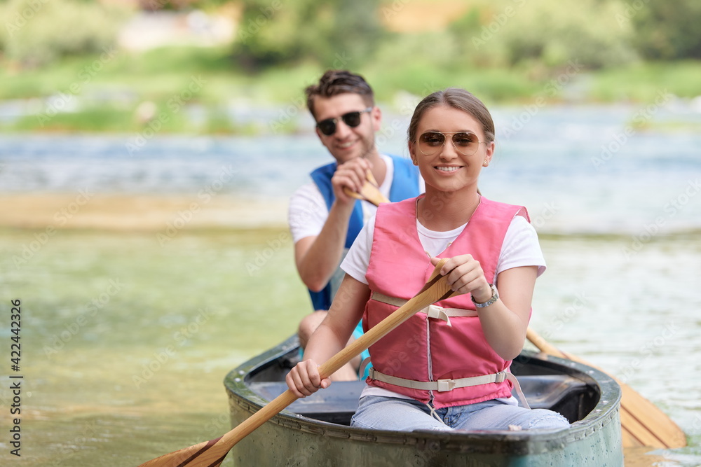 Obraz premium friends are canoeing in a wild river