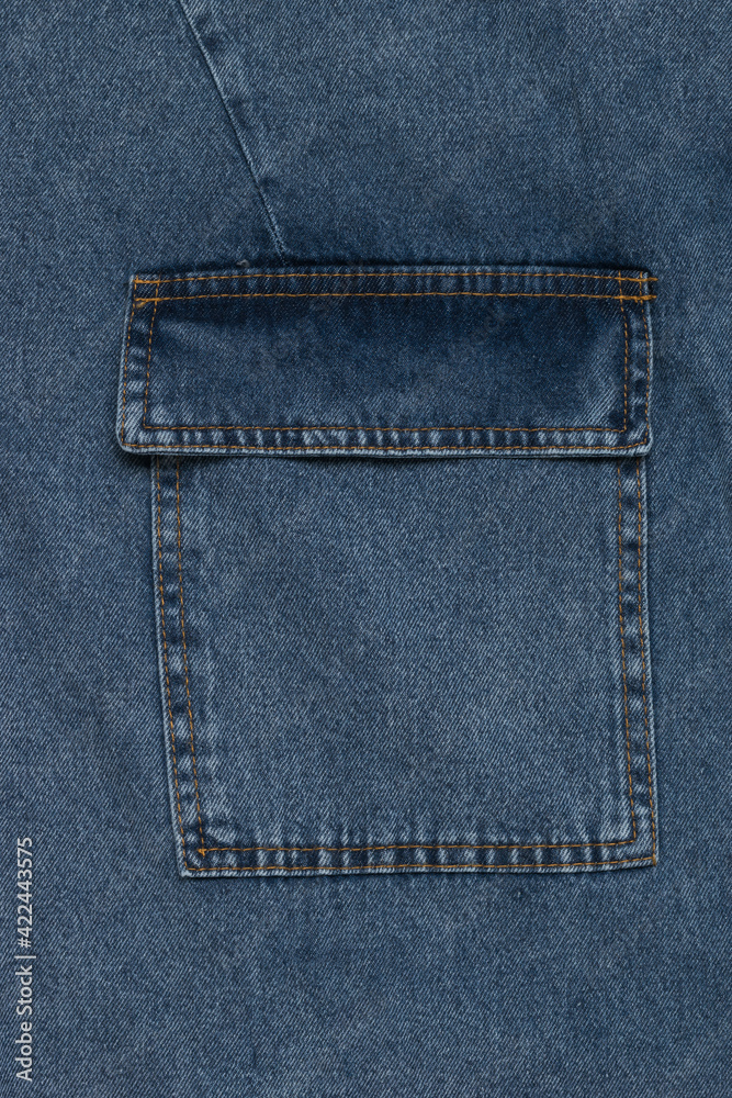 Blue denim background with large patch pocket. Blue denim background with large patch pocket.