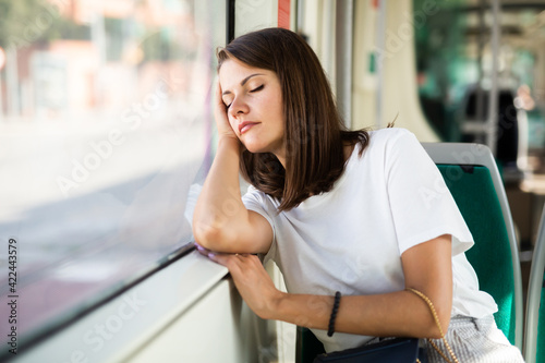 Portrait of positive girl passenger relaxing with closed eyes enjoying trip at public transport in modern tram Free Download Portrait of positive girl passenger relaxing with closed eyes enjoying trip at public transport in modern tram - GFXLoad