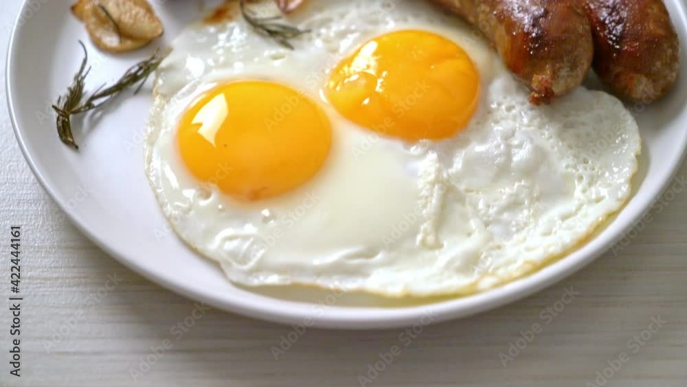 homemade double fried egg with fried pork sausage - for breakfast homemade double fried egg with fried pork sausage - for breakfast