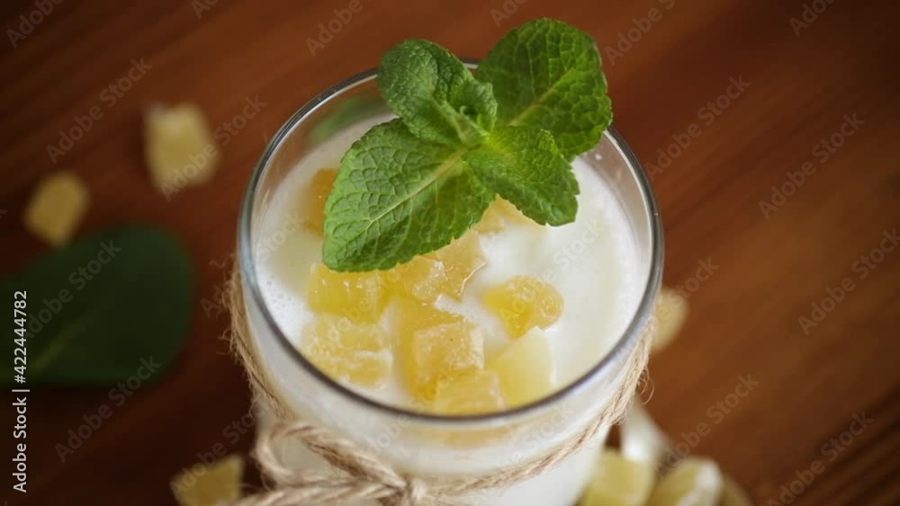 Sweet homemade yogurt with candied fruits in a glass