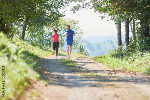 couple enjoying in a healthy lifestyle while jogging on a country road © .shock