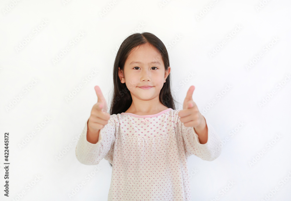 Portrait Asian little kid girl child pointing at you and looking camera isolated on blue background. Child point two index fingers to front Portrait Asian little kid girl child pointing at you and looking camera isolated on blue background. Child point two index fingers to front