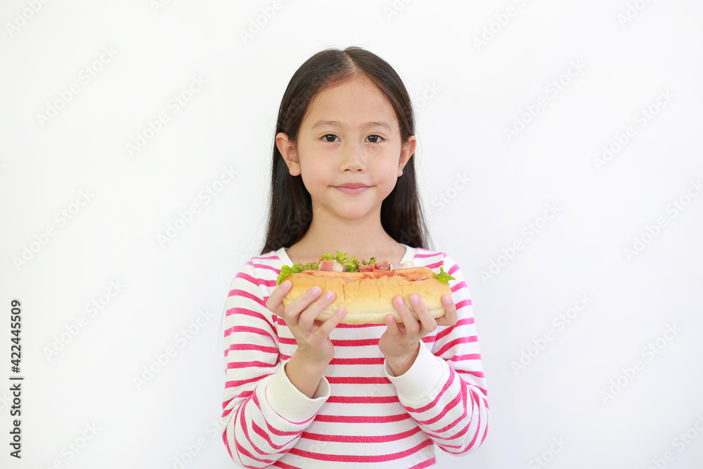 Asian little child girl holding HOT DOG for you on white background. Focus at kid face Asian little child girl holding HOT DOG for you on white background. Focus at kid face