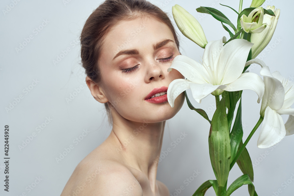 woman with white flowers on gray background portrait close-up makeup mode