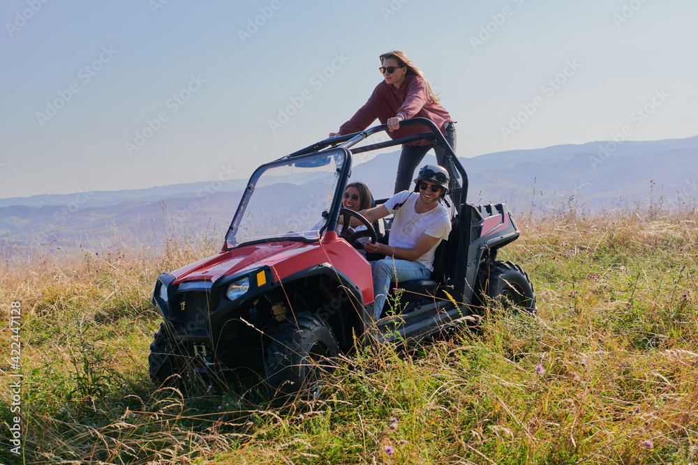 group young happy people enjoying beautiful sunny day while driving a off road buggy car group young happy people enjoying beautiful sunny day while driving a off road buggy car