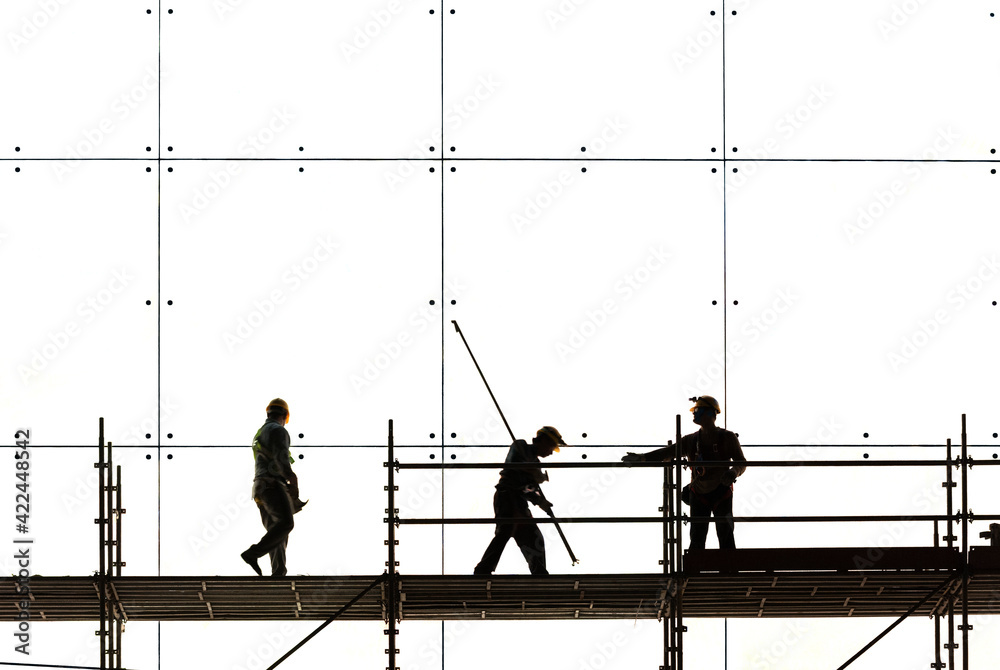 silhouette of worker at work in construction site