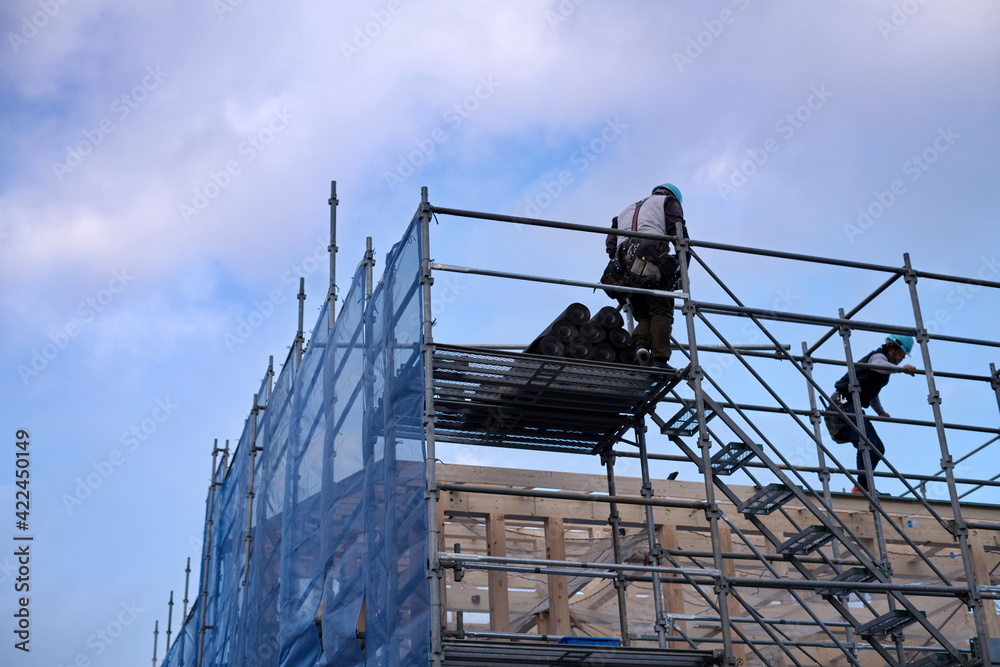 A worker at the housing construction site with wooden Framework construction, TOKYO, JAPAN - 18TH FEB 2021.