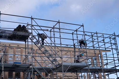 A worker at the housing construction site with wooden Framework construction, TOKYO, JAPAN - 18TH FEB 2021.