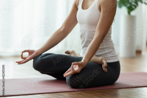 Calm of Attractive Asian woman practice yoga lotus pose to meditation in bedroom after wake up in the morning Feeling so comfortable and relax at home,Health care and Exercise at home Concept