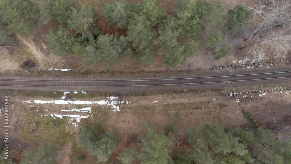 AERIAL: Railway in a Forest on a Gloomy Cloudy Day in Springtime AERIAL: Railway in a Forest on a Gloomy Cloudy Day in Springtime