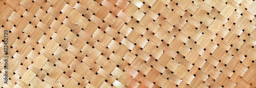 wicker basket or woven basket texture and pattern, Bamboo woven textured, detail handcraft bamboo weaving texture backgrounds, with yellowed colors natural. applicable backgrounds banner, wallpaper. 