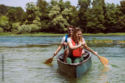 friends are canoeing in a wild river © .shock