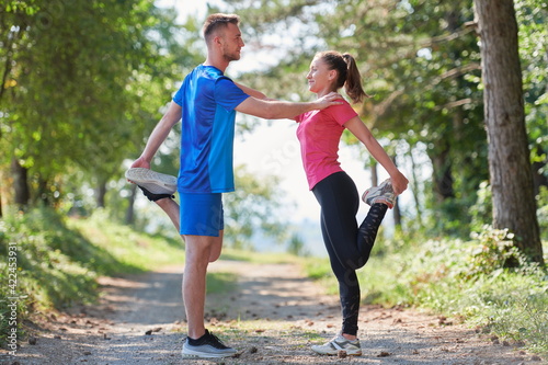 Fototapeta Naklejka Na Ścianę i Meble -  couple enjoying in a healthy lifestyle warming up and stretching before jogging