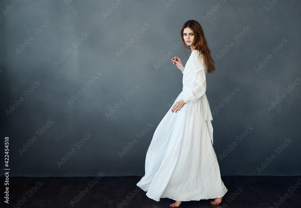 Woman in white dress on gray background red hair model romance Copy Space Woman in white dress on gray background red hair model romance Copy Space