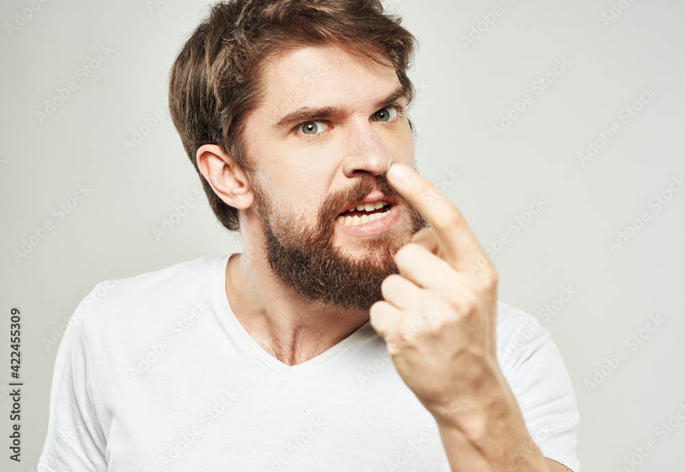 The guy in the T-shirt shows the index finger and emotions model an indignant look The guy in the T-shirt shows the index finger and emotions model an indignant look