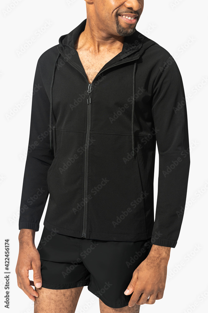 Man wearing black rash guard and blue swim shorts Man wearing black rash guard and blue swim shorts