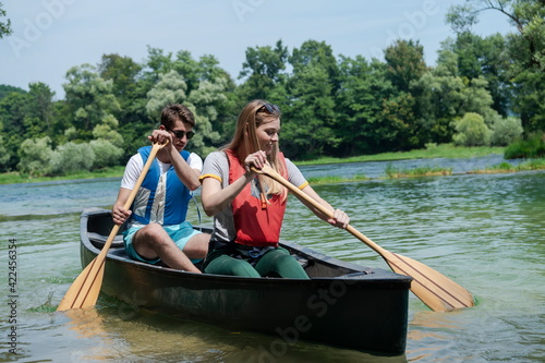 friends are canoeing in a wild river