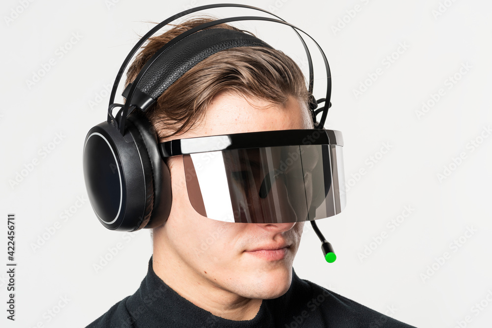 Man with smart glasses and headphones futuristic technology