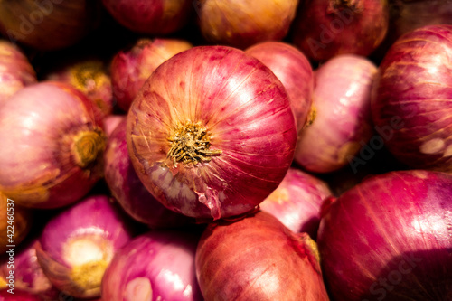 fresh red bulb onions group isolated on basket