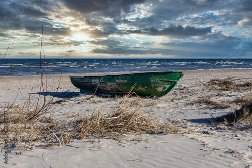 Old boat on the beach by the sea