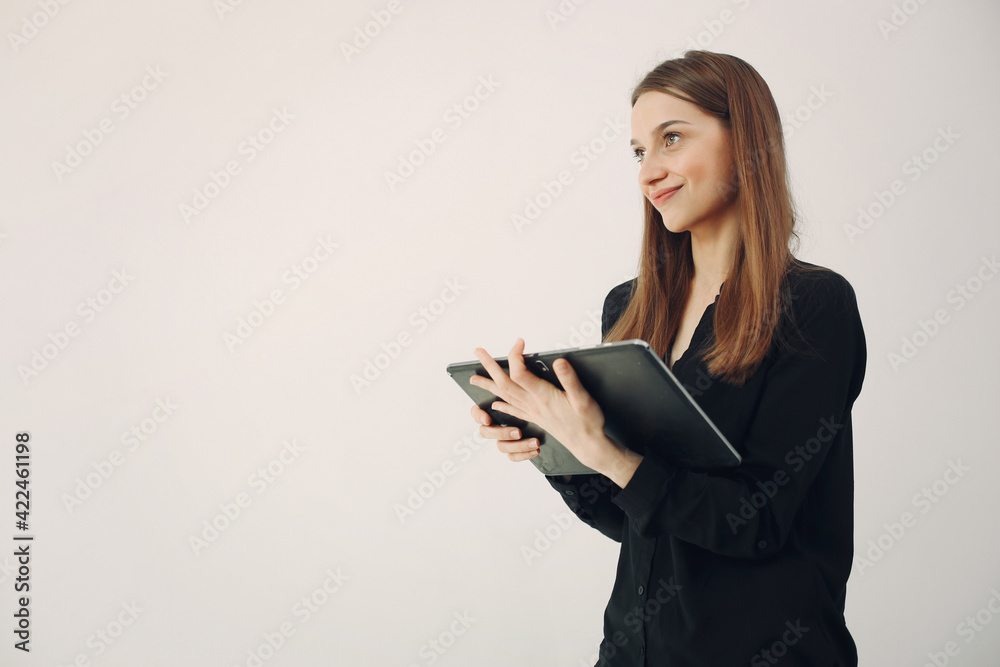 Girl standing on a white background with a laptop Girl standing on a white background with a laptop