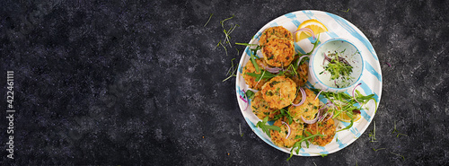 Homemade fish croquette with white fish, bulgur, spinach and breadcrumbs. Fritters from minced cod. Delicious and nutritious lunch or dinner. Top view, overhead