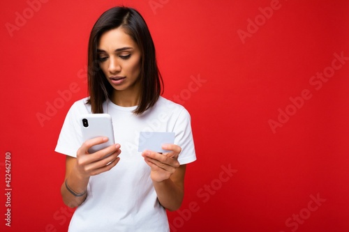 Photos Beautiful young woman wearing casual clothes standing isolated over background s