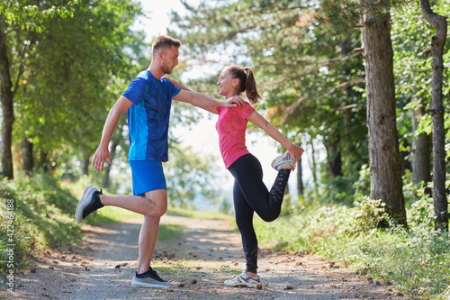 Fototapeta Naklejka Na Ścianę i Meble -  couple enjoying in a healthy lifestyle warming up and stretching before jogging