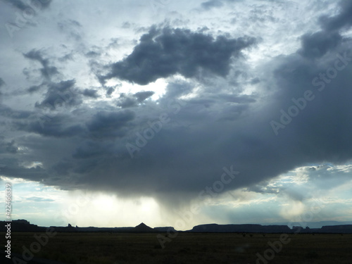 Storm clouds and rain over a highway near the Badlands in South Dakota © Jen