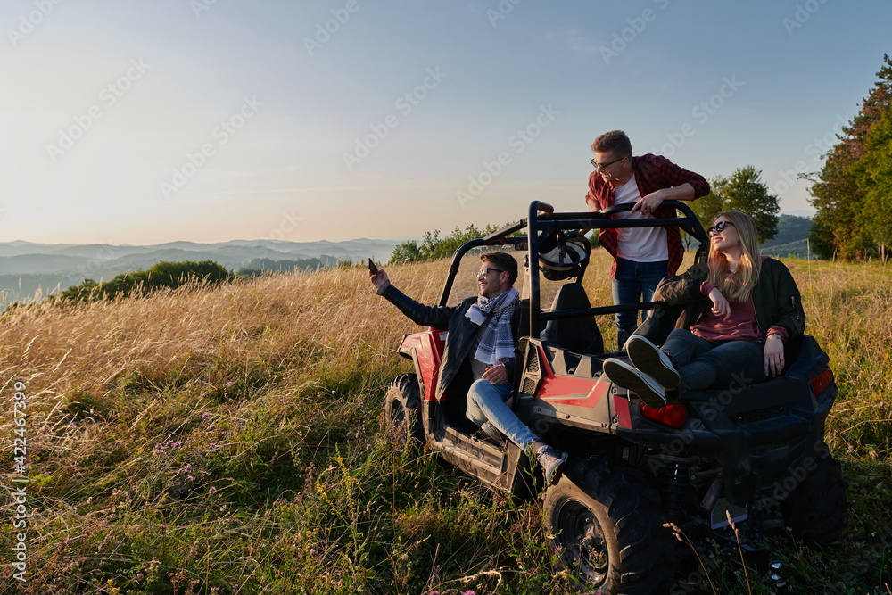 group young happy people enjoying beautiful sunny day while driving a off road buggy car group young happy people enjoying beautiful sunny day while driving a off road buggy car