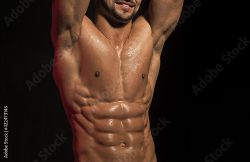 Boy Powered. Men skin care. Bare chest of man with muscular body on black background. Sexy muscled male model strong nude body..