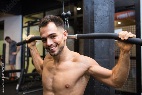 muscular man lifting weights in the gym