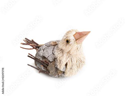 Little bird figurine, perspective view. Small sparrow type bird figure, made with straw strings, clay and sticks. Easter, spring or party table decoration concept. Isolated on white.